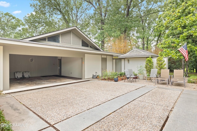 1 Eureka Plantation Rd, Lafayette, LA 70508 - view of front facade with a patio and stucco siding