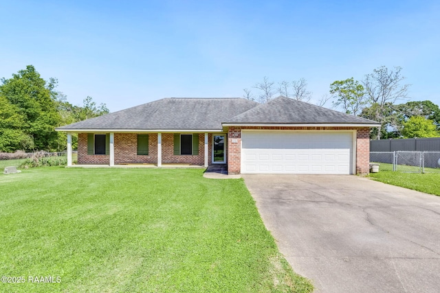 ranch-style home with concrete driveway, a front lawn, brick siding, a garage, and fence
