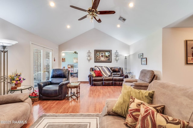 living room featuring light wood-style floors, ceiling fan, visible vents, recessed lighting, and lofted ceiling