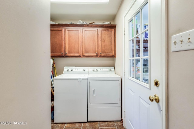 clothes washing area featuring cabinet space and washing machine and clothes dryer