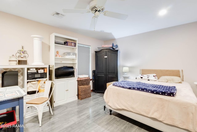 bedroom featuring visible vents, ceiling fan, and light wood-style flooring
