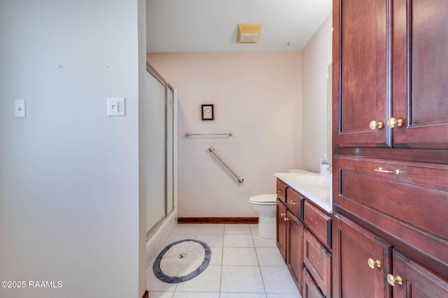 bathroom featuring a stall shower, vanity, baseboards, and tile patterned flooring