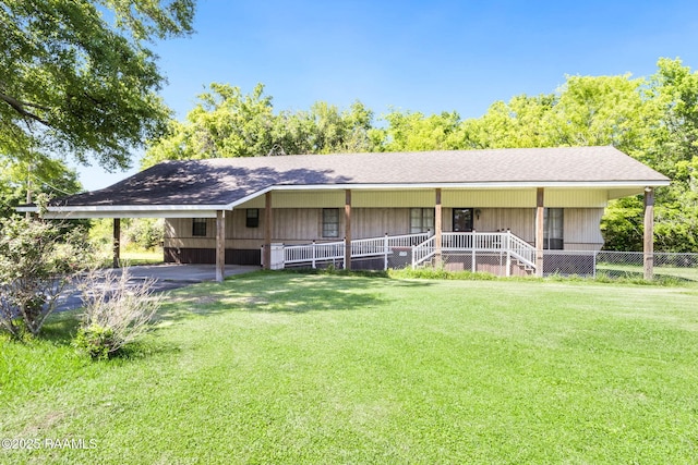 view of front of home with a porch, a front yard, and an attached carport