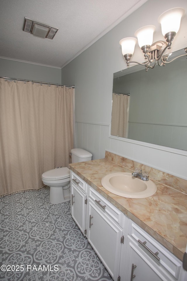 140 Saint Leo St, Opelousas, LA 70570 - full bathroom with vanity, ornamental molding, visible vents, a wainscoted wall, and toilet