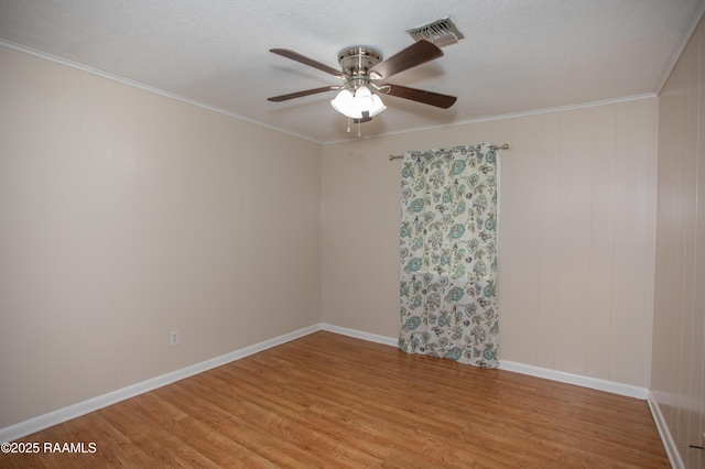 140 Saint Leo St, Opelousas, LA 70570 - empty room with light wood-type flooring, baseboards, ornamental molding, visible vents, and ceiling fan