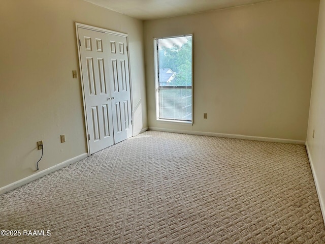 701 S College Rd Apt 309, Lafayette, LA 70503 - unfurnished bedroom with carpet floors, a closet, and baseboards