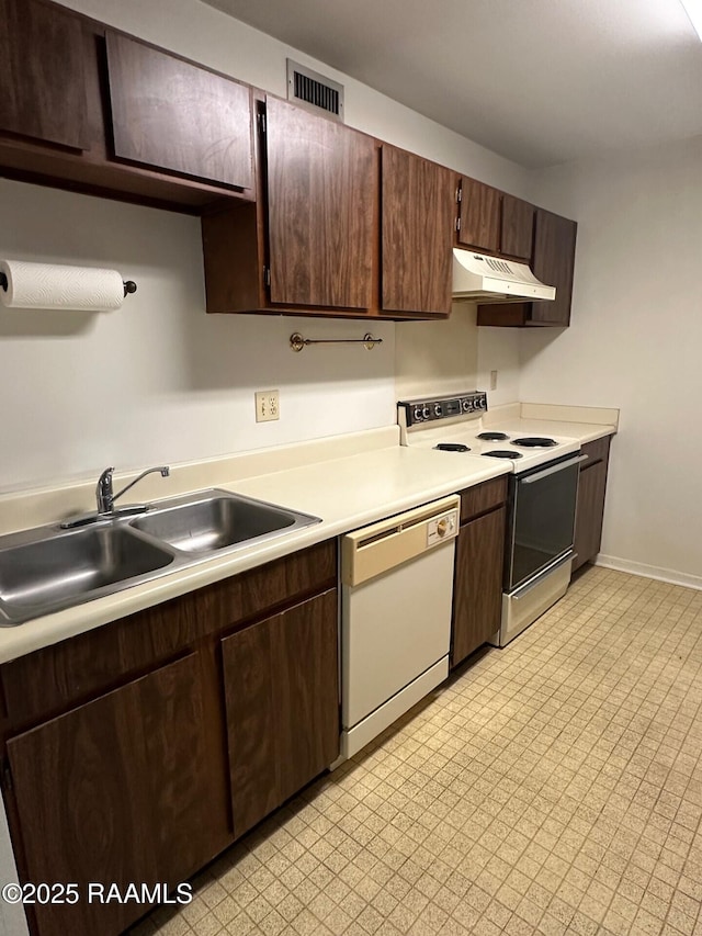 701 S College Rd Apt 309, Lafayette, LA 70503 - kitchen with a sink, electric range, white dishwasher, light countertops, and under cabinet range hood