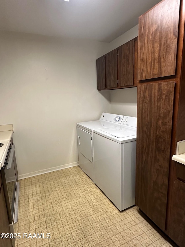701 S College Rd Apt 309, Lafayette, LA 70503 - clothes washing area with cabinet space, washing machine and clothes dryer, baseboards, and light floors