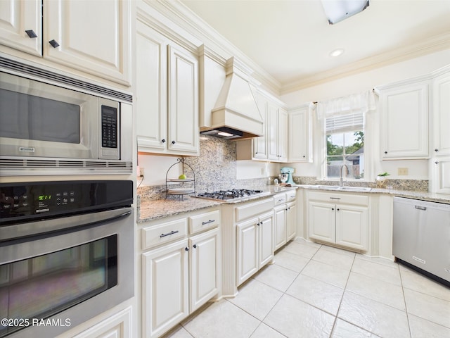 111 Croft Row, Lafayette, LA 70503 - kitchen with decorative backsplash, appliances with stainless steel finishes, light tile patterned floors, a sink, and custom exhaust hood