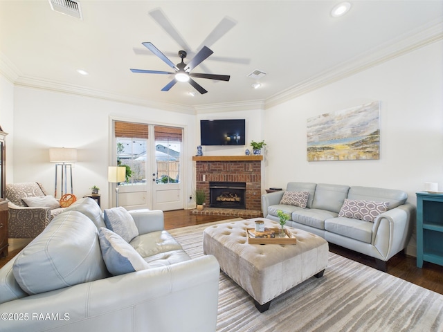 111 Croft Row, Lafayette, LA 70503 - living area with crown molding, ceiling fan, a brick fireplace, wood finished floors, and visible vents