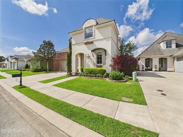 111 Croft Row, Lafayette, LA 70503 - view of front of home with an attached garage, stucco siding, a front yard, and concrete driveway