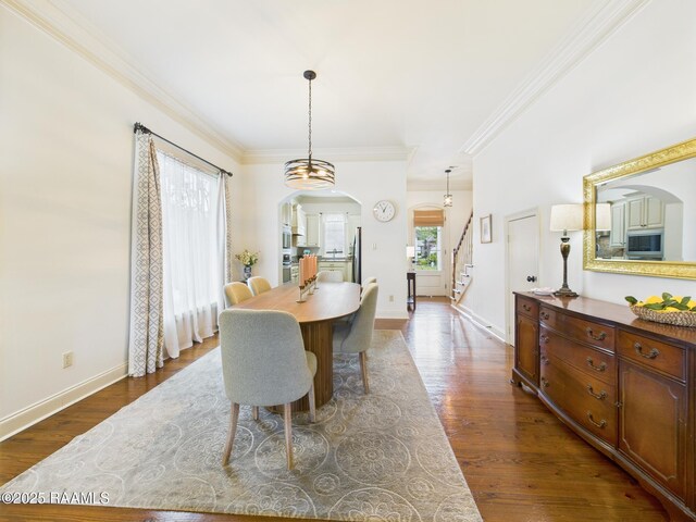 111 Croft Row, Lafayette, LA 70503 - dining area featuring arched walkways, crown molding, stairway, and dark wood-type flooring