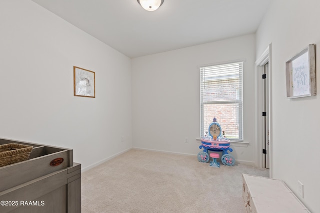 interior space with baseboards and light carpet