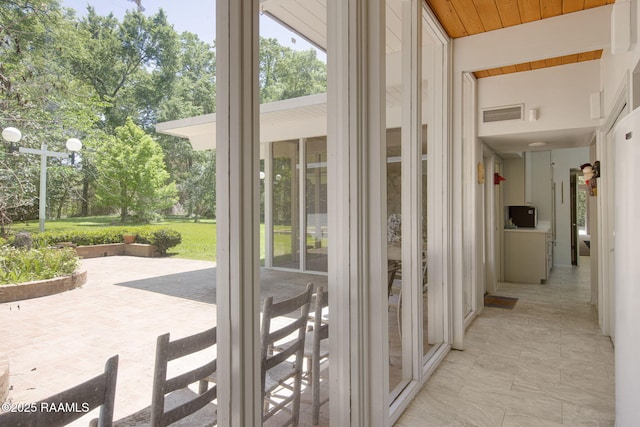entryway featuring wood ceiling, visible vents, and a wealth of natural light