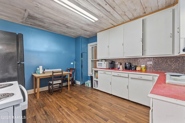 kitchen with white cabinets, light countertops, white appliances, wood finished floors, and backsplash
