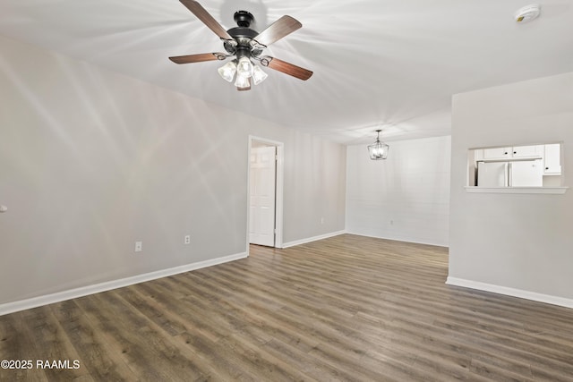 701 S College Rd Unit 303, Lafayette, LA 70503 - spare room featuring baseboards, wood finished floors, and ceiling fan with notable chandelier