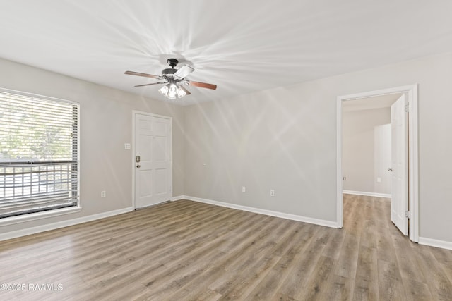 701 S College Rd Unit 303, Lafayette, LA 70503 - spare room with baseboards, a ceiling fan, and wood finished floors