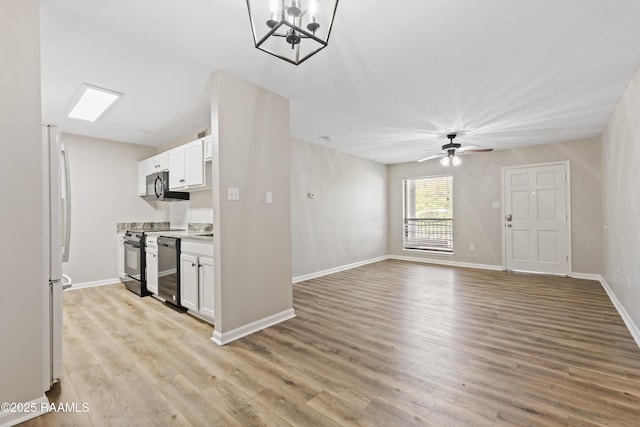 701 S College Rd Unit 303, Lafayette, LA 70503 - kitchen with white cabinetry, ceiling fan with notable chandelier, black appliances, and light wood finished floors