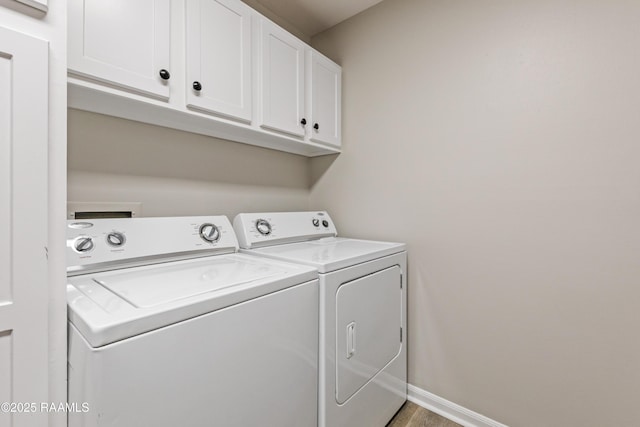 701 S College Rd Unit 303, Lafayette, LA 70503 - washroom featuring baseboards, cabinet space, and washer and clothes dryer