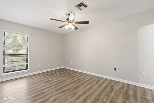 701 S College Rd Unit 303, Lafayette, LA 70503 - spare room featuring visible vents, baseboards, a ceiling fan, and wood finished floors