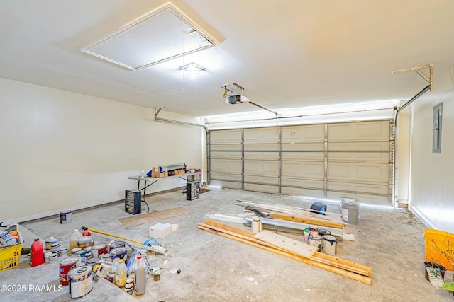 garage with a garage door opener and electric panel