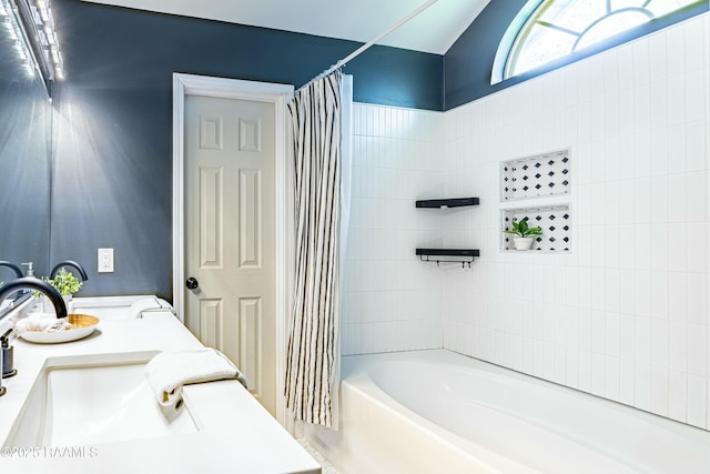 bathroom featuring a sink and shower / bathtub combination with curtain