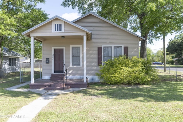 bungalow featuring a front yard, entry steps, and fence