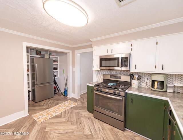 1207 Oak St, Ville Platte, LA 70586 - kitchen with light countertops, stainless steel appliances, baseboards, and white cabinetry