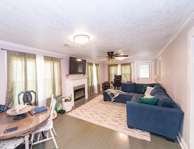 1207 Oak St, Ville Platte, LA 70586 - living room with ornamental molding, a ceiling fan, wood finished floors, and a wealth of natural light
