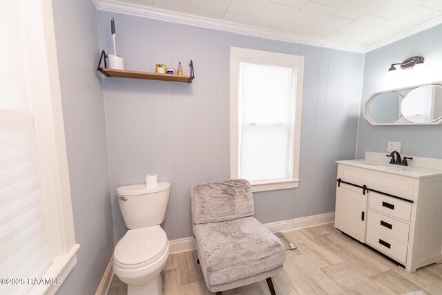 1207 Oak St, Ville Platte, LA 70586 - bathroom with vanity, ornamental molding, toilet, and wood finished floors