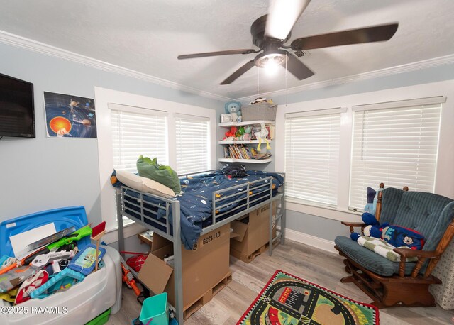 1207 Oak St, Ville Platte, LA 70586 - bedroom with crown molding, baseboards, ceiling fan, and wood finished floors