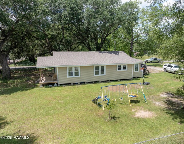 1207 Oak St, Ville Platte, LA 70586 - view of front of property featuring a shingled roof, a playground, and a front yard