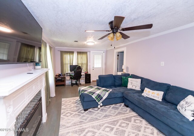 1207 Oak St, Ville Platte, LA 70586 - living area with crown molding, ceiling fan, a textured ceiling, wood finished floors, and a tile fireplace