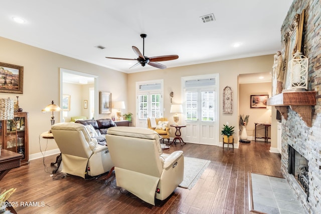 202 N Anita St, Lafayette, LA 70501 - living room featuring ceiling fan, dark wood-style flooring, visible vents, and a fireplace