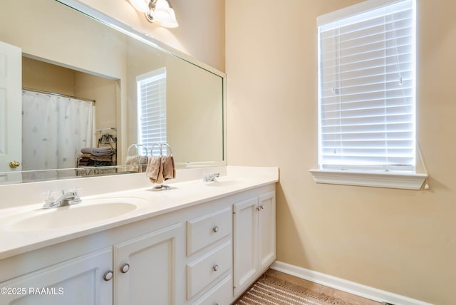 202 N Anita St, Lafayette, LA 70501 - bathroom with tile patterned flooring, baseboards, a sink, and double vanity
