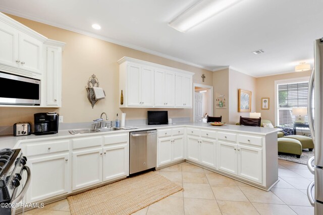 202 N Anita St, Lafayette, LA 70501 - kitchen featuring a peninsula, ornamental molding, stainless steel appliances, and light tile patterned floors