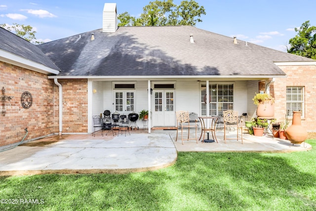 202 N Anita St, Lafayette, LA 70501 - rear view of property with a chimney, brick siding, a patio area, and roof with shingles