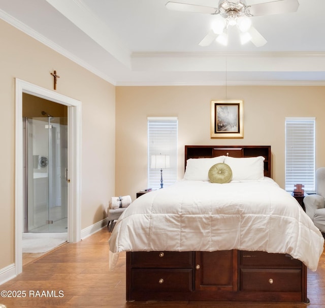 202 N Anita St, Lafayette, LA 70501 - bedroom with crown molding, wood finished floors, ceiling fan, a raised ceiling, and baseboards