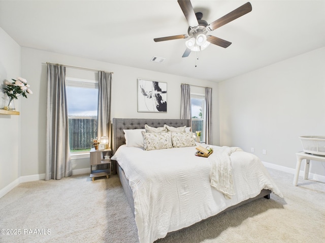 carpeted bedroom featuring baseboards and a ceiling fan