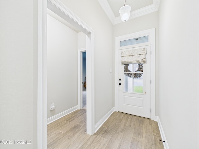 entrance foyer with ornamental molding, light wood finished floors, and baseboards
