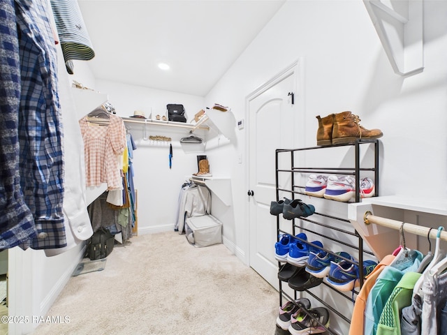 walk in closet featuring carpet flooring