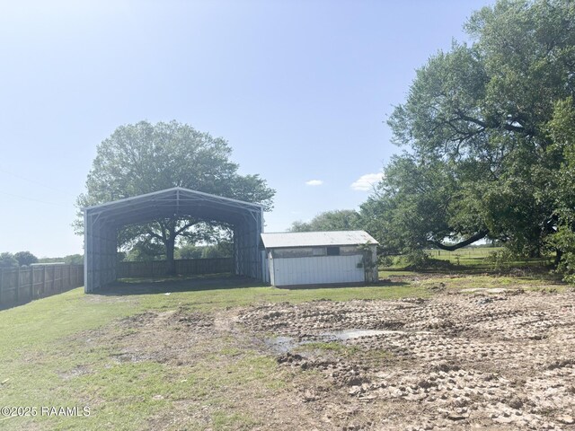 view of yard featuring a detached carport and fence