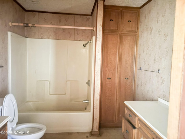 bathroom featuring toilet, wallpapered walls, vanity, and shower / bathing tub combination