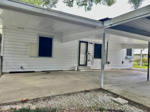 view of patio featuring entry steps and an attached carport