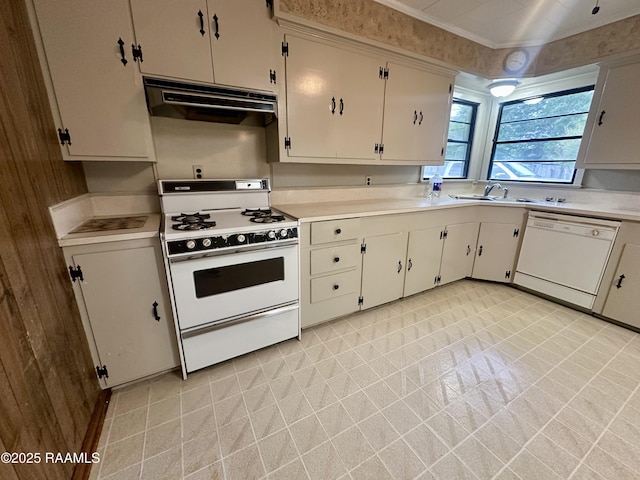 kitchen featuring under cabinet range hood, a sink, light countertops, and white appliances