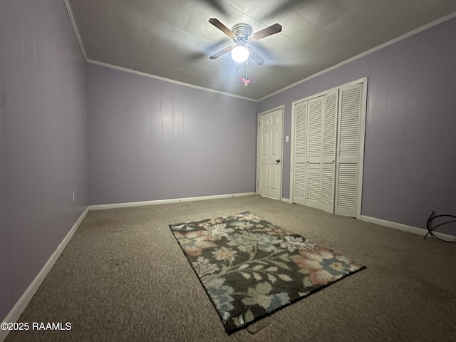 unfurnished bedroom with crown molding, baseboards, and carpet