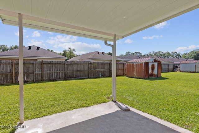 111 Bottle Brush Ln, Carencro, LA 70520 - view of yard with an outbuilding, a fenced backyard, a patio area, and a storage unit