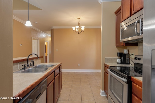 111 Bottle Brush Ln, Carencro, LA 70520 - kitchen featuring crown molding, tile counters, a chandelier, a sink, and appliances with stainless steel finishes
