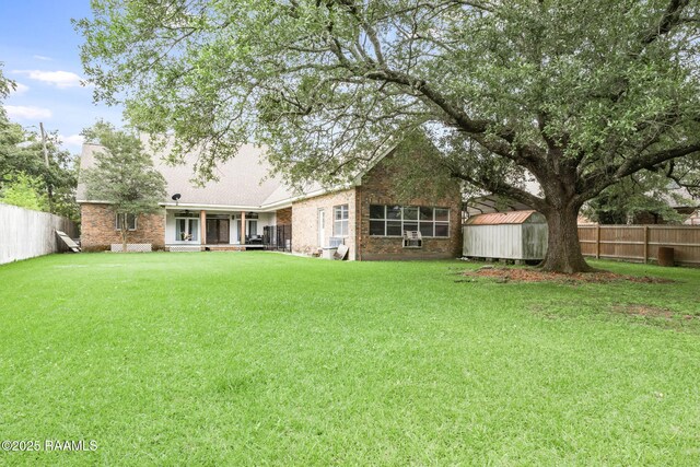 4615 Loreauville Rd, New Iberia, LA 70563 - back of house with brick siding, a shed, an outdoor structure, and a sunroom
