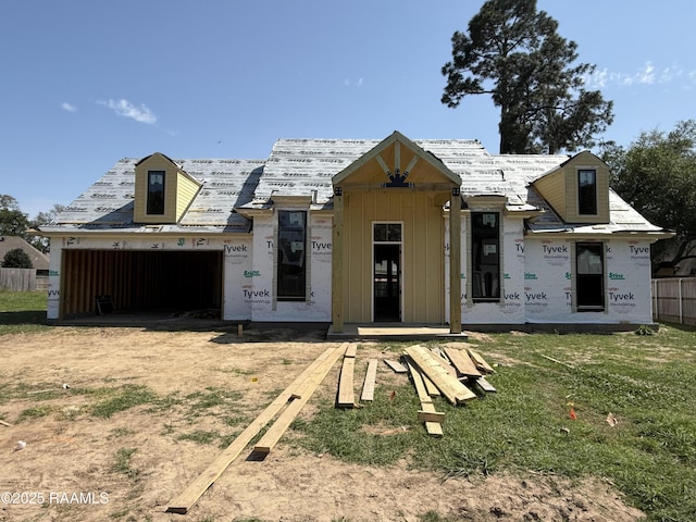 property in mid-construction featuring board and batten siding, a garage, fence, and dirt driveway